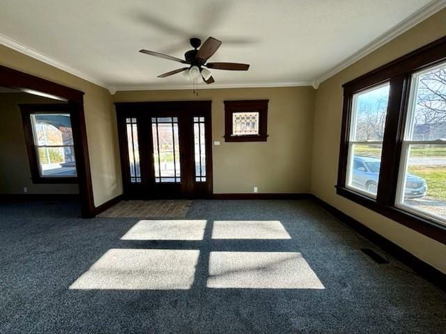 spare room with dark carpet, ceiling fan, and ornamental molding