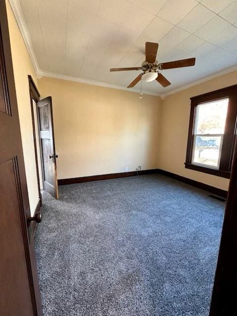 empty room featuring ceiling fan, ornamental molding, and carpet floors