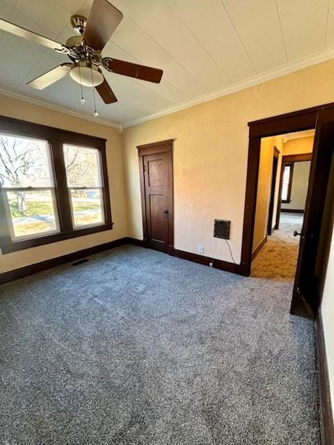 spare room with carpet floors, ceiling fan, and ornamental molding