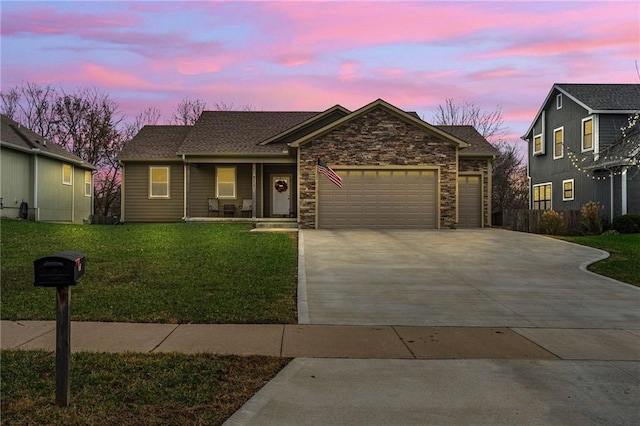 view of front facade with a garage and a yard