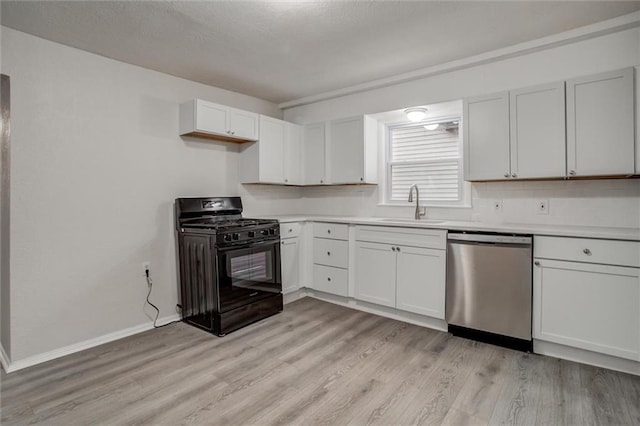 kitchen featuring black gas stove, white cabinets, stainless steel dishwasher, and sink