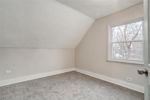 bonus room featuring carpet flooring and lofted ceiling