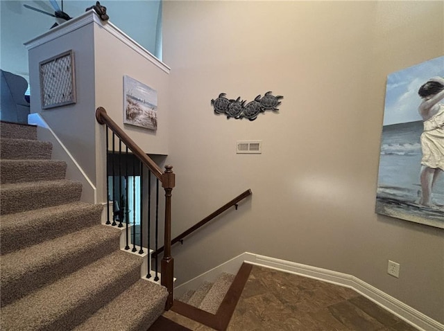 stairs featuring a high ceiling