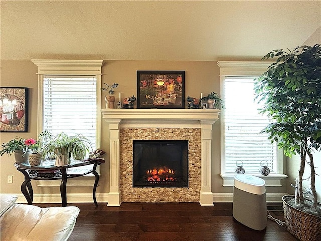 sitting room with a tile fireplace and dark hardwood / wood-style flooring