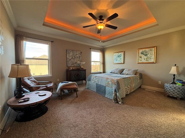 bedroom with ceiling fan, ornamental molding, and a tray ceiling