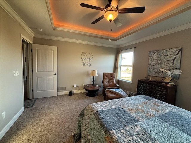 bedroom featuring carpet, ceiling fan, a raised ceiling, and crown molding