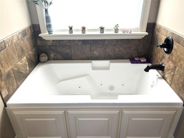 bathroom with a healthy amount of sunlight and a tub