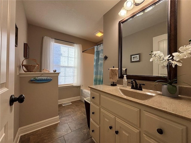 bathroom with tile patterned flooring and vanity