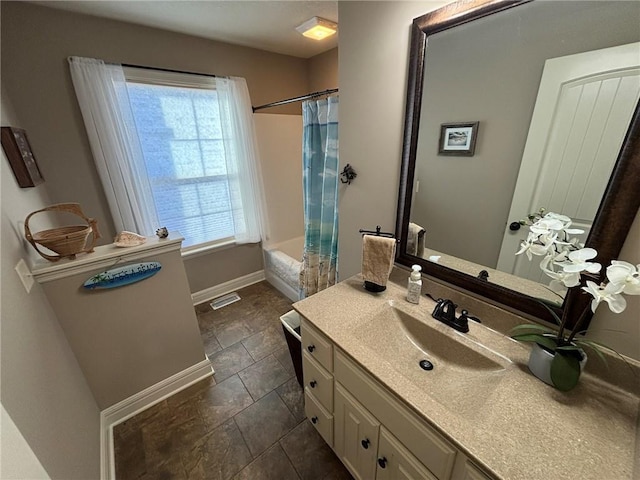 bathroom featuring tile patterned floors, shower / bath combo, a healthy amount of sunlight, and vanity