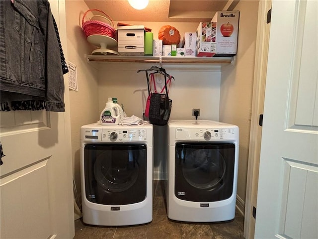 clothes washing area featuring separate washer and dryer