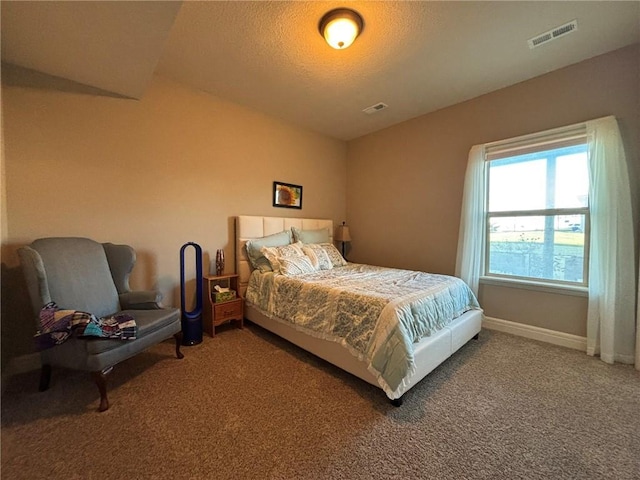 bedroom with a textured ceiling and carpet floors