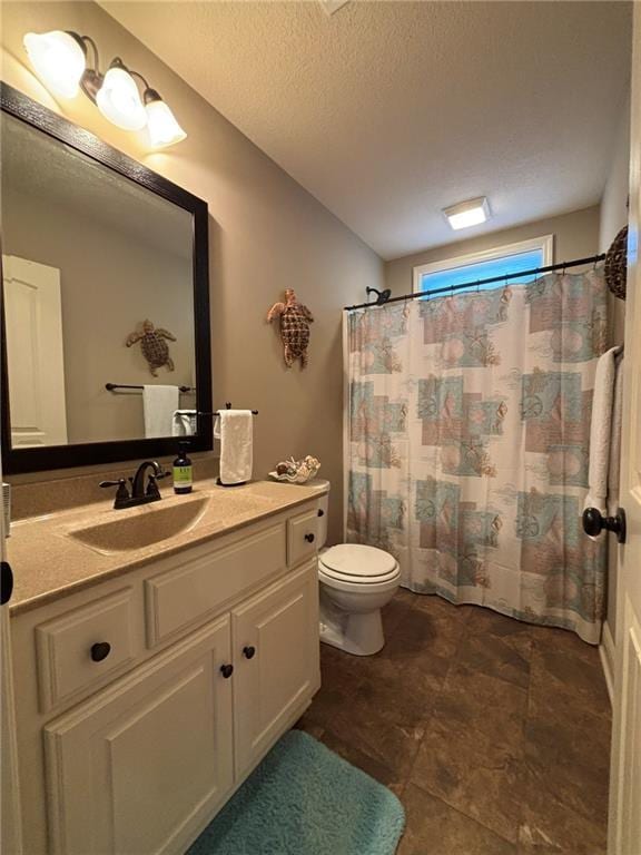 bathroom featuring vanity, a shower with shower curtain, a textured ceiling, and toilet