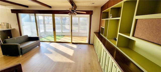 interior space featuring ceiling fan and beam ceiling