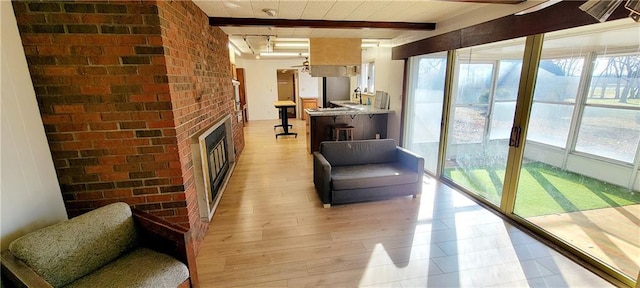 interior space with beam ceiling and a fireplace