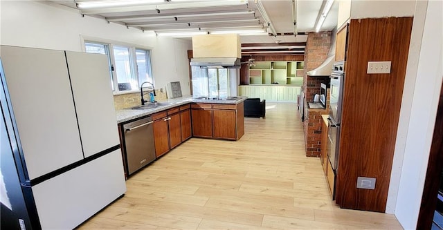 kitchen featuring refrigerator, kitchen peninsula, light hardwood / wood-style floors, sink, and dishwasher