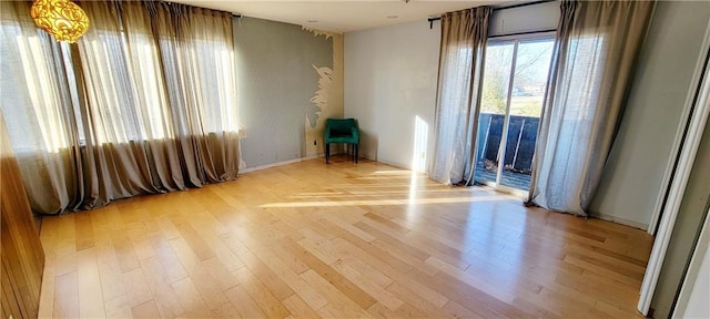 unfurnished room with light wood-type flooring