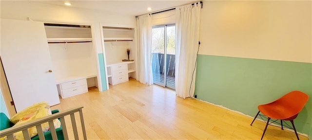 bedroom featuring light wood-type flooring and access to outside