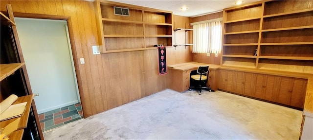 home office with wooden walls and built in desk