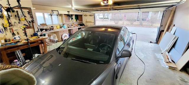 garage featuring a garage door opener and a workshop area