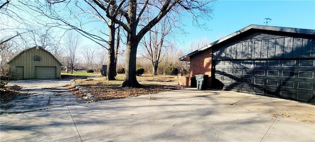 view of home's exterior with a garage and an outbuilding