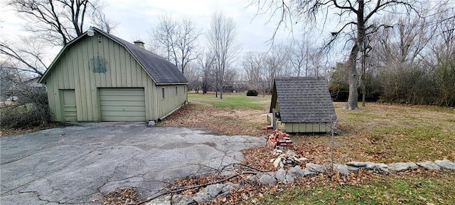 exterior space with a garage and an outdoor structure