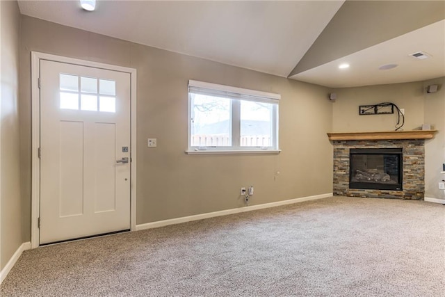 unfurnished living room featuring carpet floors, lofted ceiling, and a fireplace