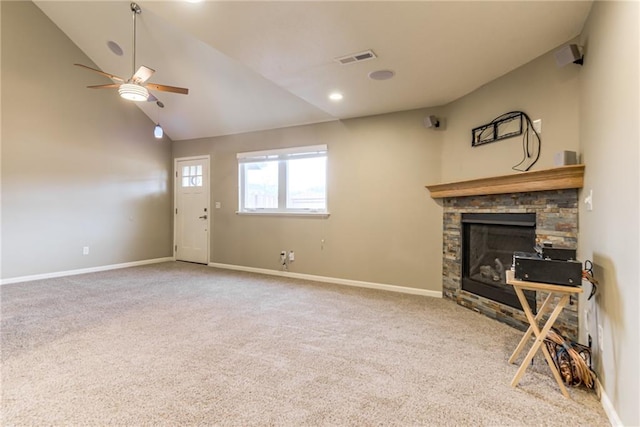 living room featuring lofted ceiling, ceiling fan, a fireplace, and carpet floors