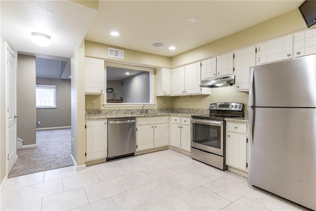 kitchen featuring sink, white cabinetry, appliances with stainless steel finishes, and light carpet