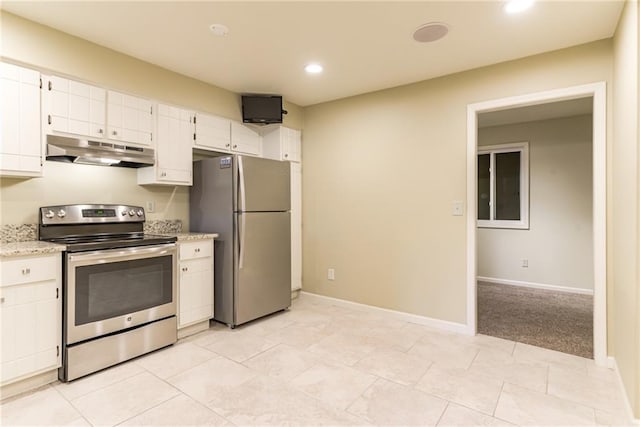 kitchen featuring light carpet, stainless steel appliances, white cabinets, and light stone countertops