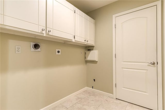 laundry area with light tile patterned floors, electric dryer hookup, and cabinets