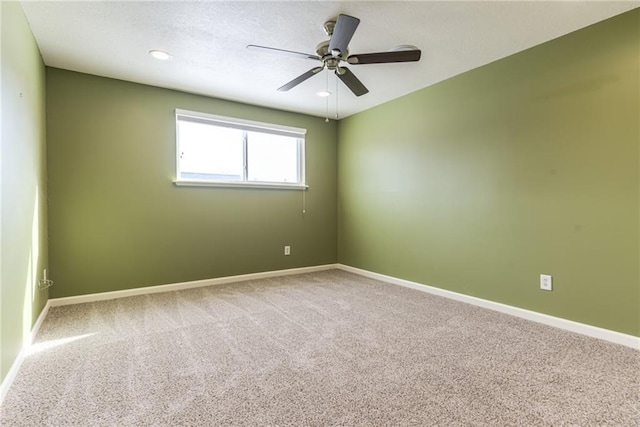 unfurnished room with carpet and ceiling fan