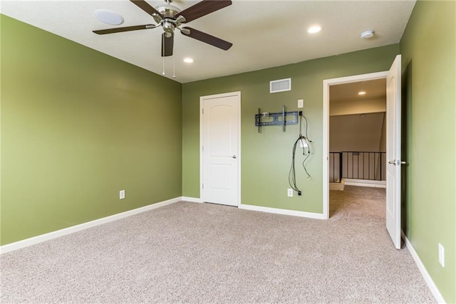 unfurnished bedroom with ceiling fan and light carpet