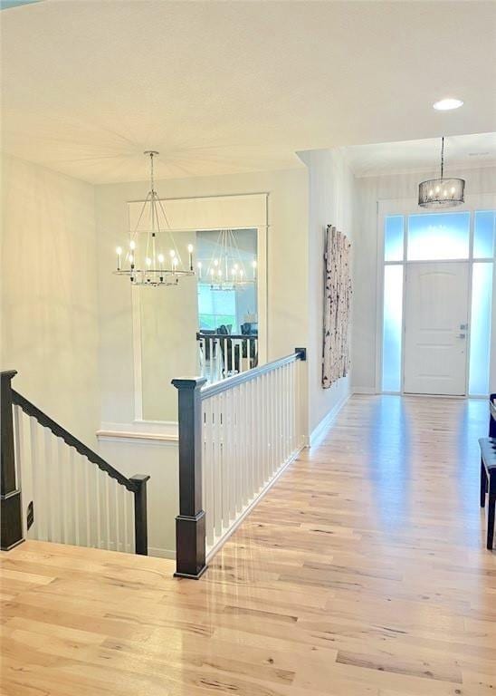 hallway with a notable chandelier and wood-type flooring