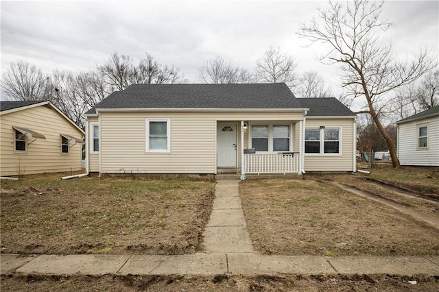 bungalow-style home with a porch and a front lawn