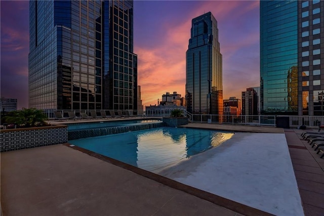 pool at dusk with a patio