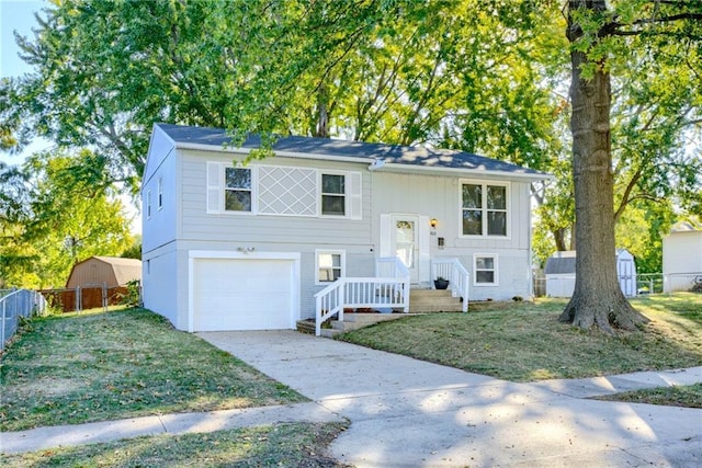 raised ranch featuring a front yard and a garage