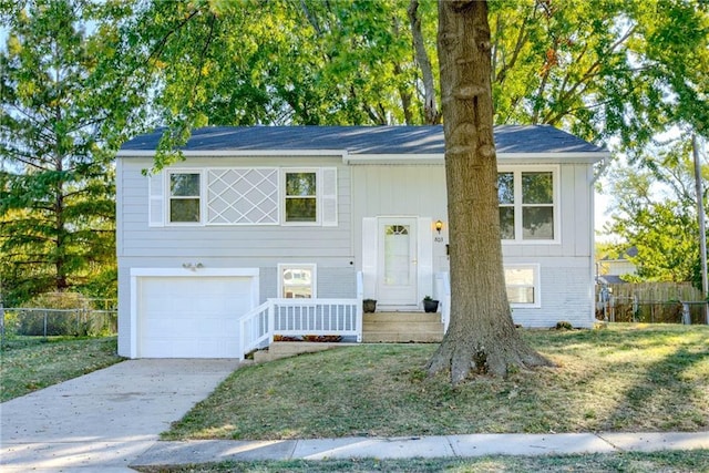 bi-level home featuring a front yard and a garage