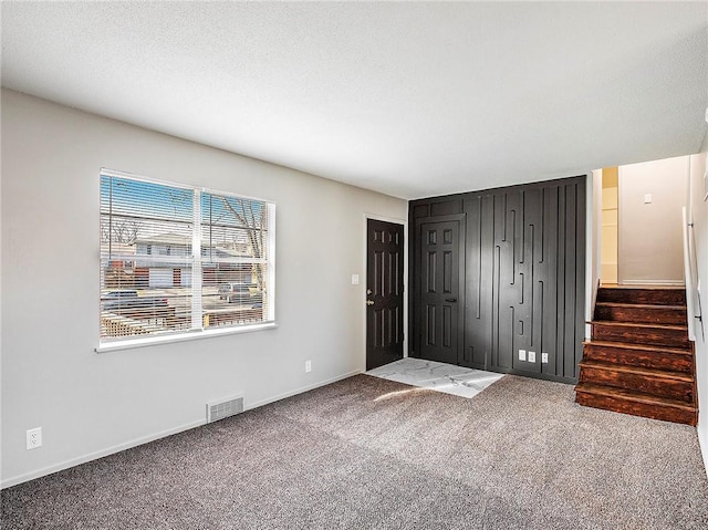 foyer featuring carpet flooring