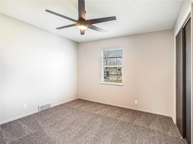 unfurnished bedroom featuring ceiling fan, a closet, and carpet