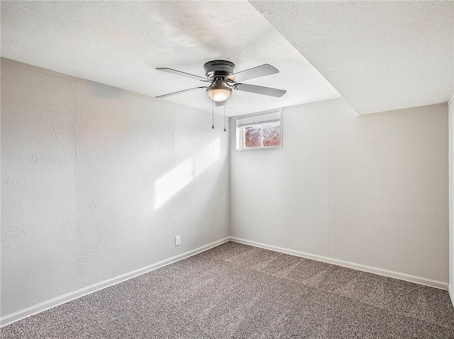 carpeted spare room featuring ceiling fan and a textured ceiling