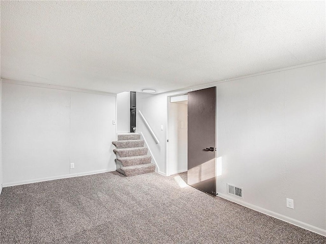 basement featuring carpet and a textured ceiling