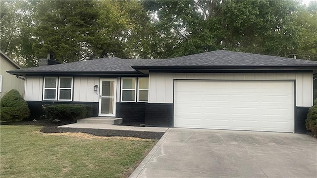 view of front facade with a front yard and a garage