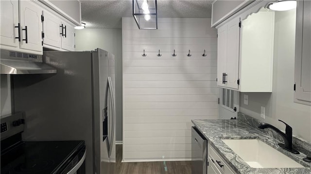 kitchen with a textured ceiling, sink, exhaust hood, electric range, and white cabinets