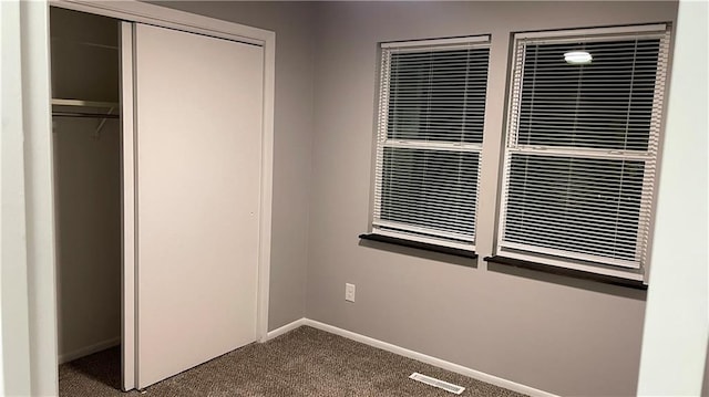 unfurnished bedroom with carpet flooring and a closet