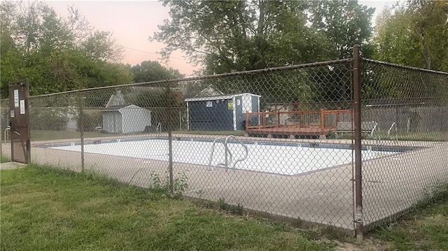 pool at dusk with a storage shed