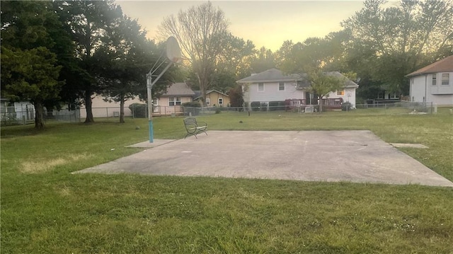 view of sport court featuring a yard