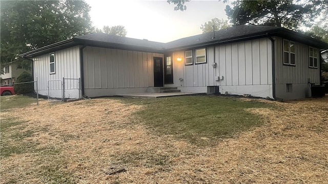 rear view of property featuring a yard