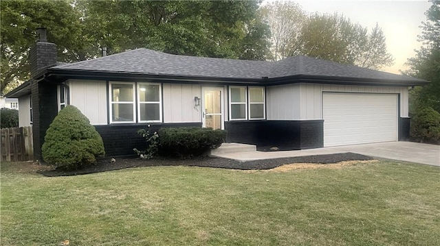 view of front of home with a front lawn and a garage