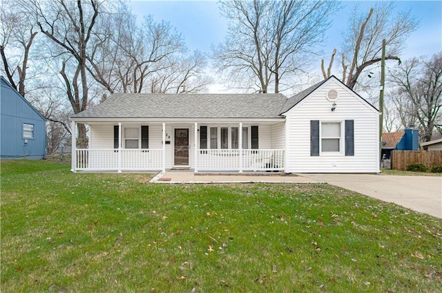 ranch-style home with covered porch and a front yard