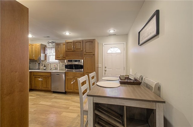 dining space featuring light hardwood / wood-style floors and sink